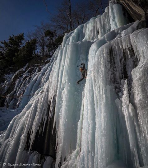 A climber trying to get up a mountain covered with ice